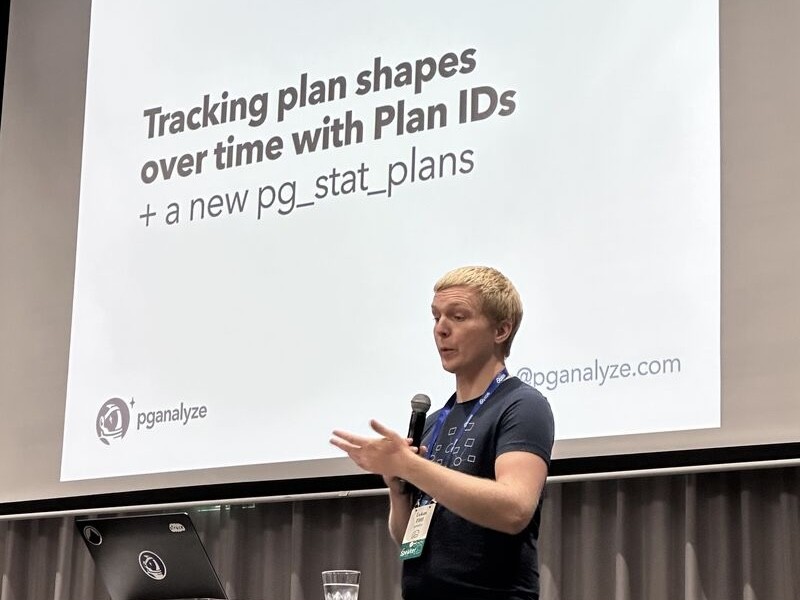 Lukas Fittl speaking at a Postgres conference